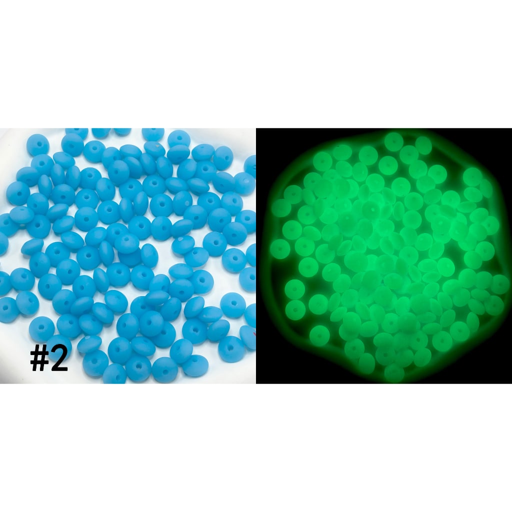 Blue beads on a white background with a close-up of glowing green beads.

