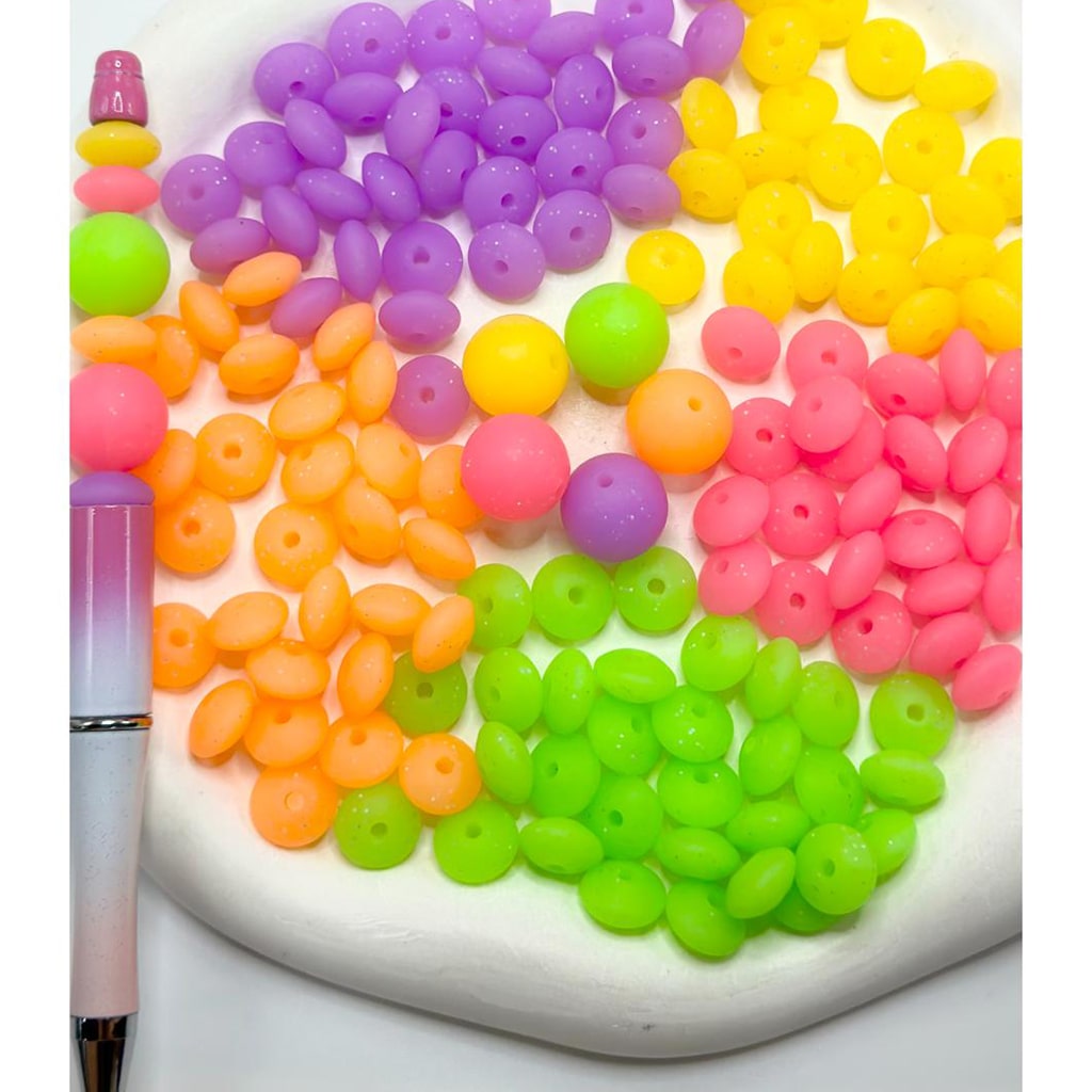 Colorful beads arranged in a circular pattern on a white surface.

