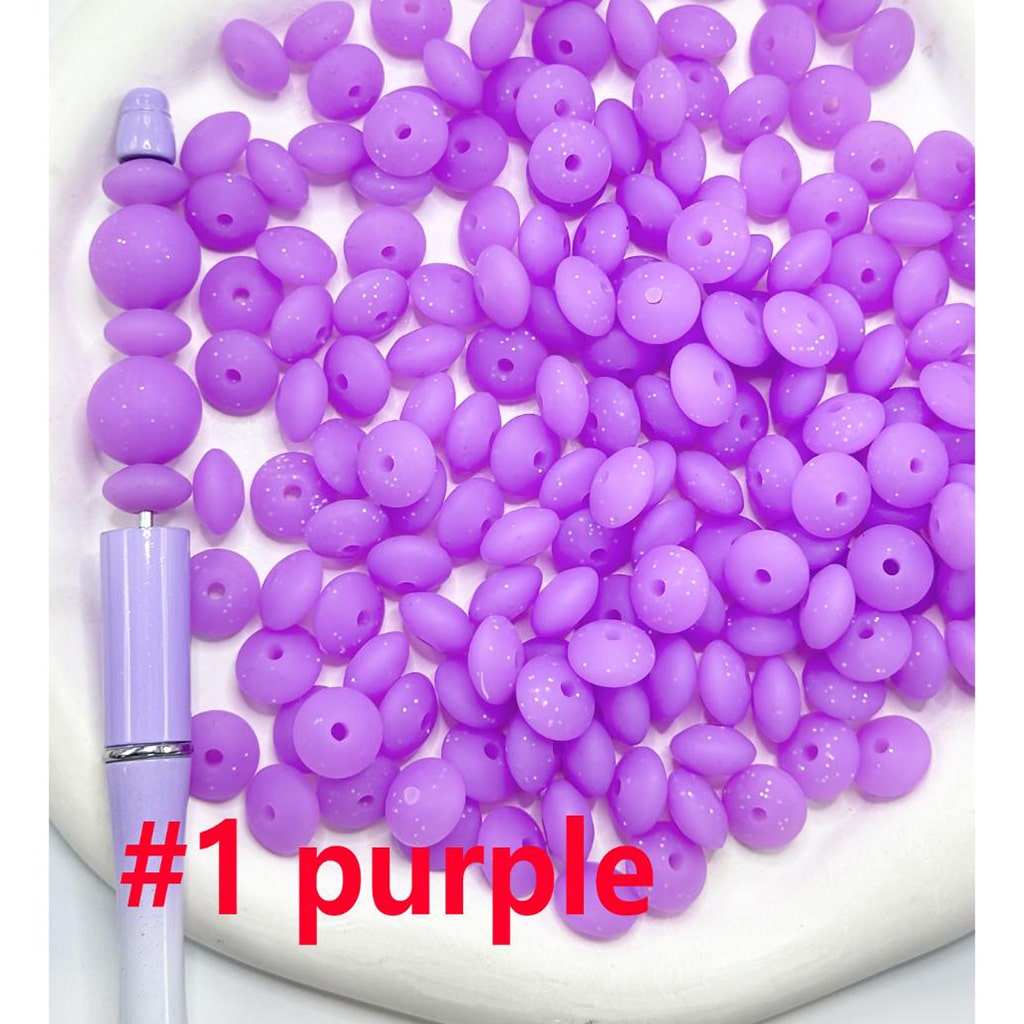 Purple beads on a white tray with a pen next to them, labeled '#1 purple'.

