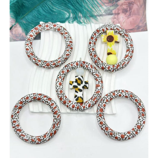 A set of silicone basketball-shaped ring frames with a jaguar animal print design, intended as car hangers or charms.


