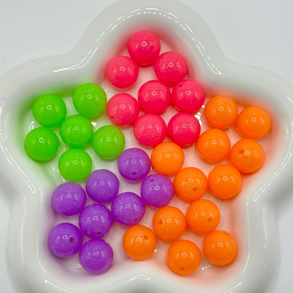 Colorful round beads in a heart-shaped dish

