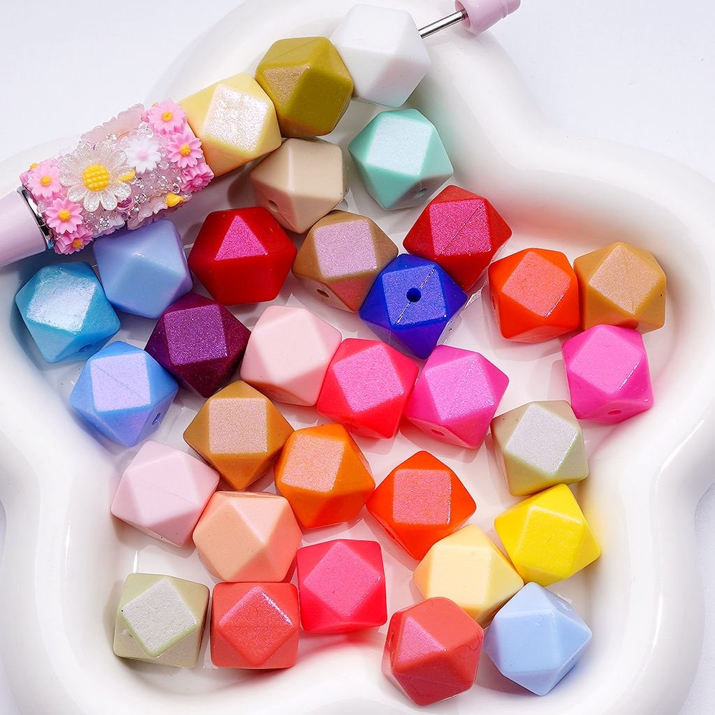 Colorful geometric beads in a white dish with a decorative handle.


