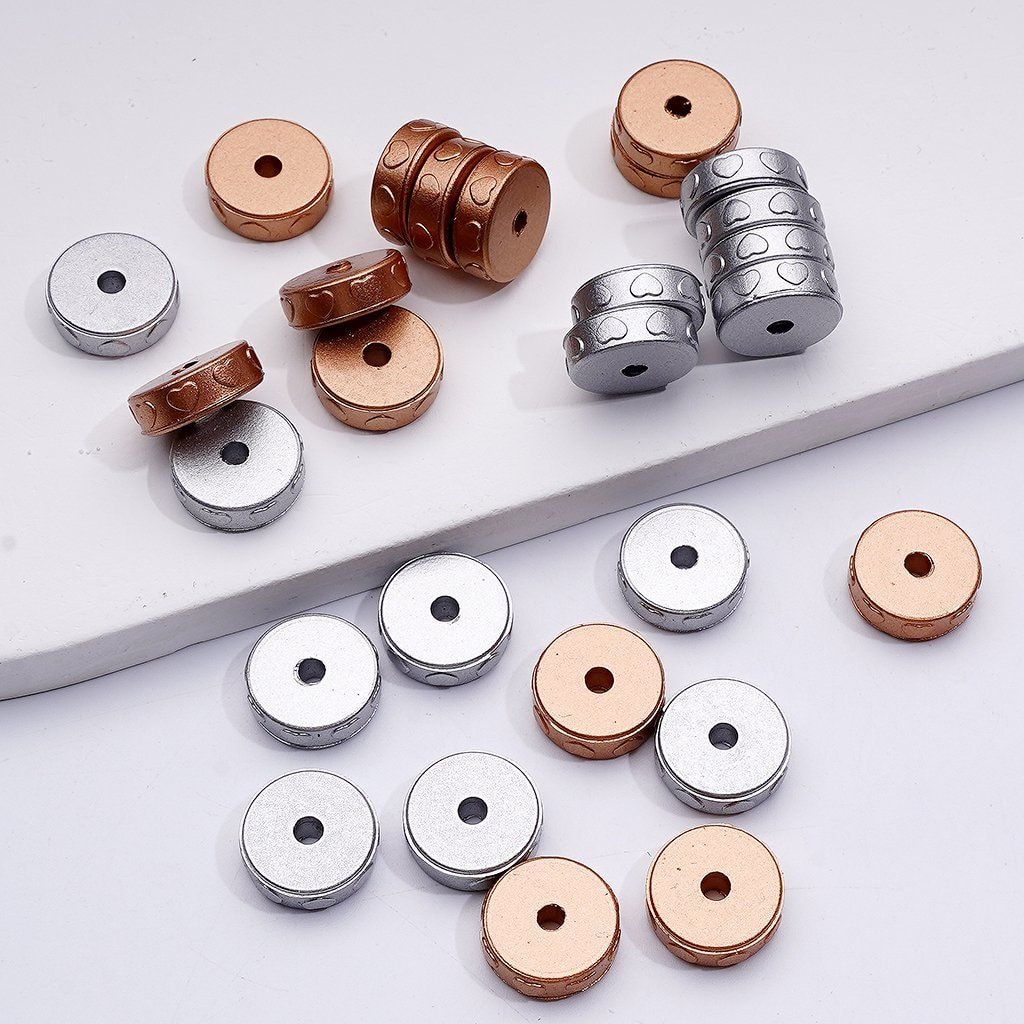 Silver and Bronze metal beads on a white background

