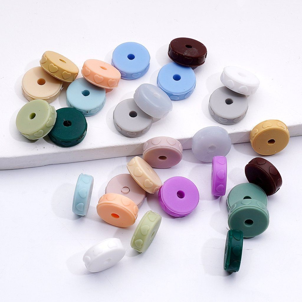 Assorted colorful buttons on a white surface

