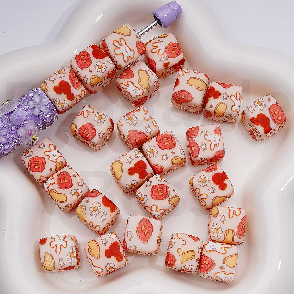 Decorative beads with cartoon designs on a white surface


