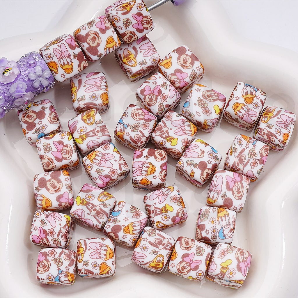 Set of decorative dice with cartoon character designs on a white surface

