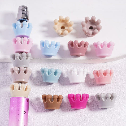 Set of colorful crown-shaped dental tools on a white background