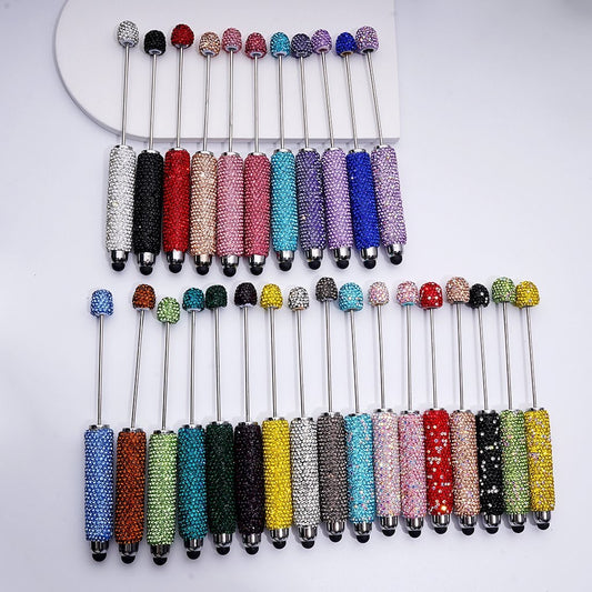 Set of colorful beaded sticks on a white background

