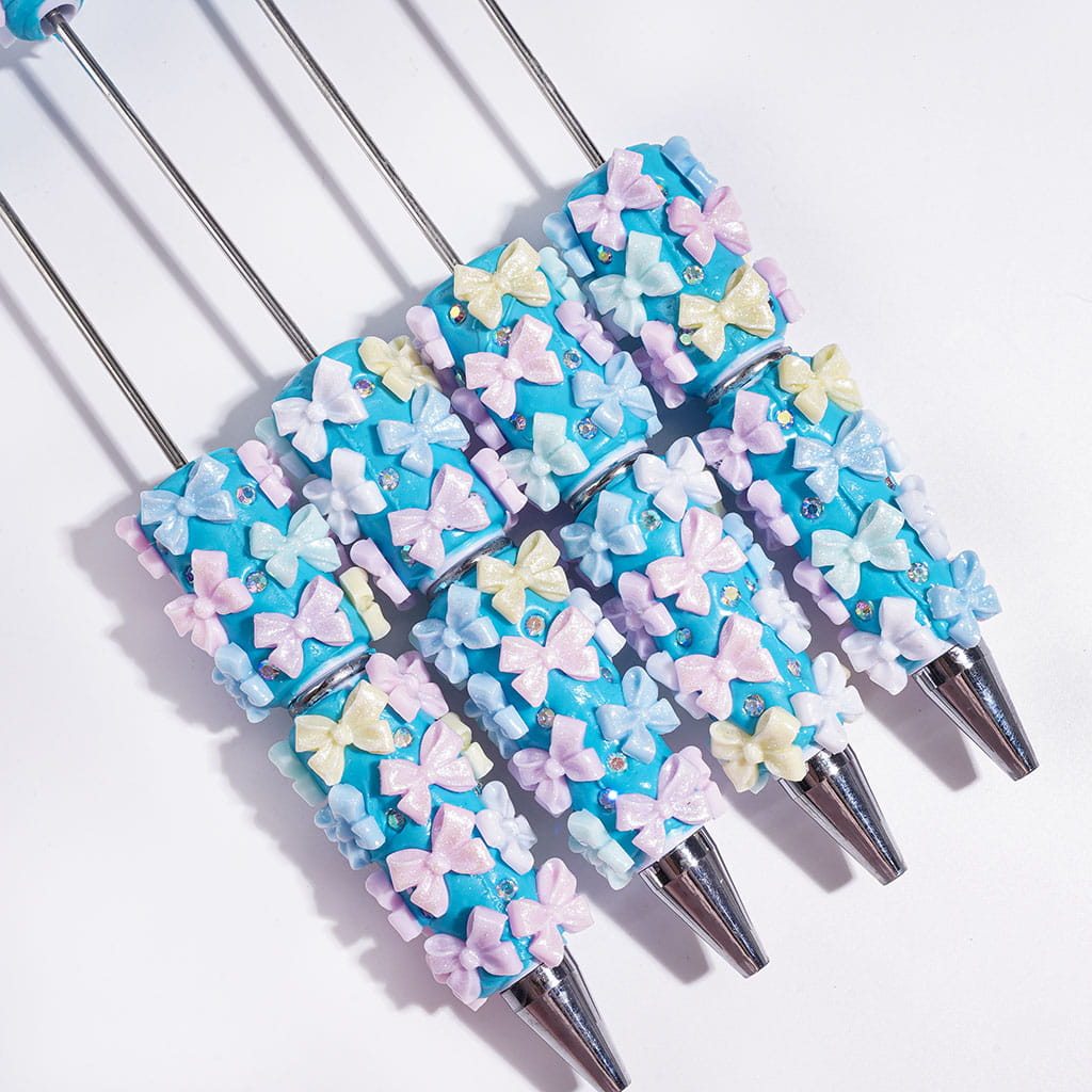 Beadable Clay Pens with Glitter Bowtie and AB Rhinestones on Blue Background