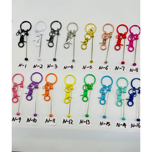 A variety of metal keychains with silicone beads and small lobster clasps in multiple colors.

