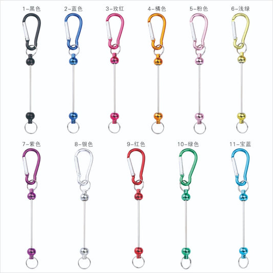 A collection of metal carabiner hooks with beadable keychain bars and snap ring keyrings in various colors.

