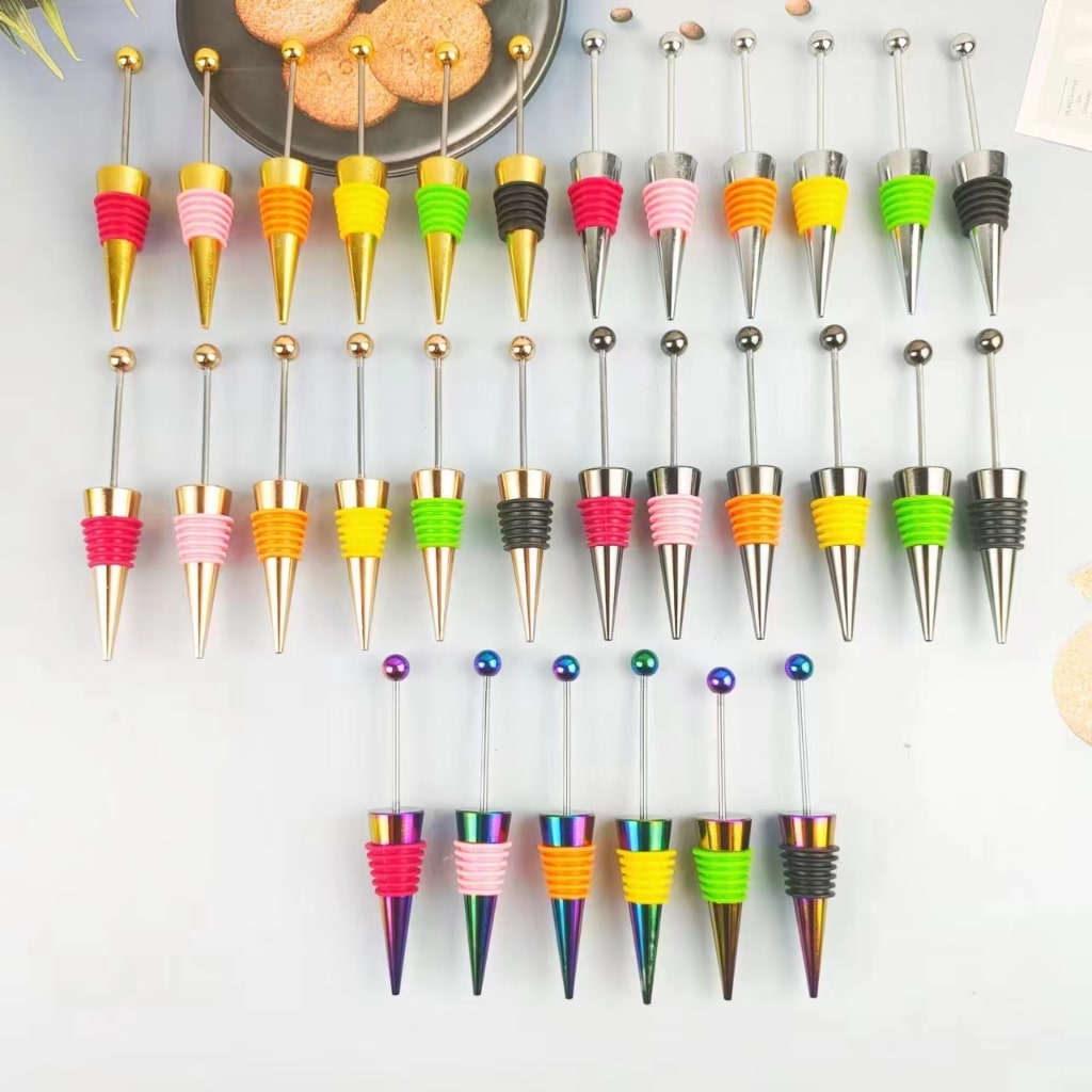 A collection of colorful wine beadable stoppers displayed on a surface.

