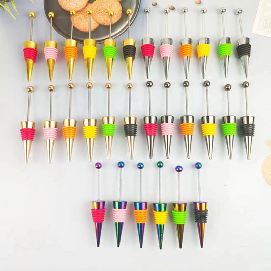A collection of colorful wine beadable stoppers displayed on a surface.

