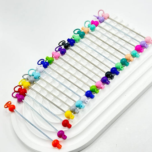 An assortment of colorful beadable bars for keychains and accessories, displayed on a white surface.

