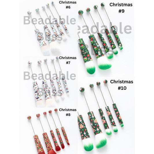 Set of Christmas-themed crochet hooks with decorative handles on a white background.


