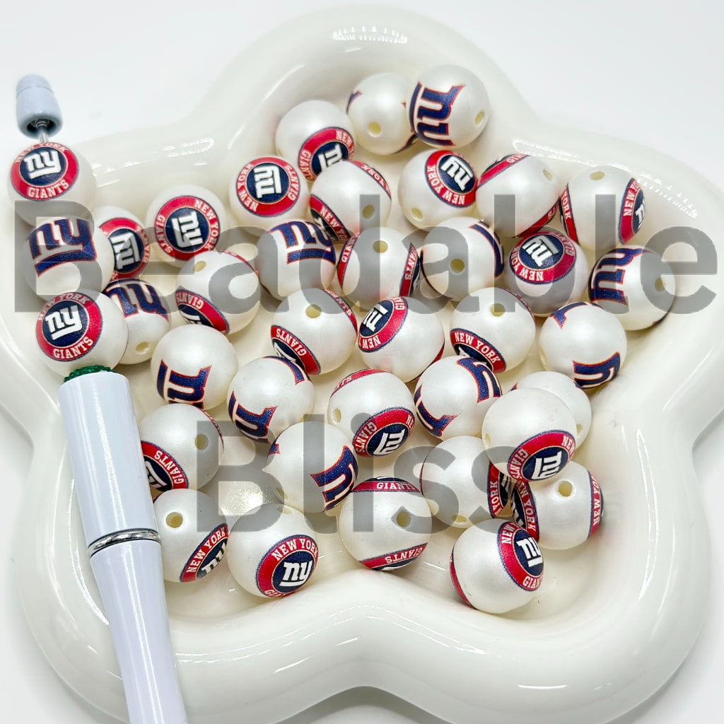 White beads with red and yellow designs on a white dish

