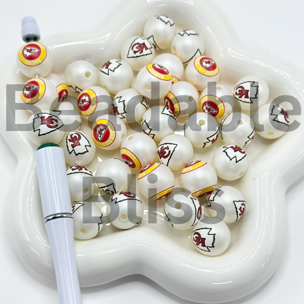 White beads with 'Cowboys' and star designs in a white container

