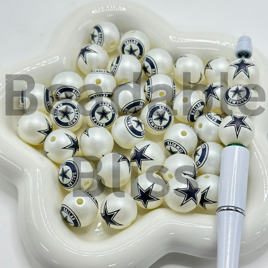 White beads with star designs in a white dish

