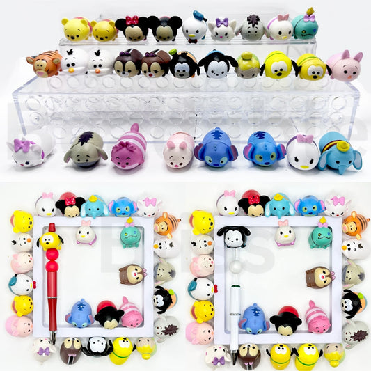 A collection of colorful cartoon character bead toppers, designed to be used on pens, displayed in various arrangements.

