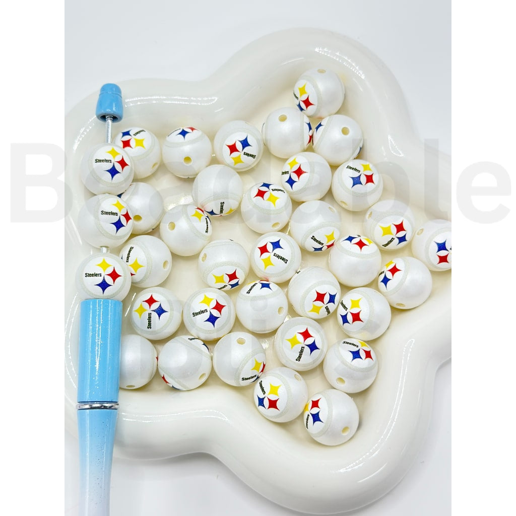 White beads with colorful logos in a heart-shaped container on a white background

