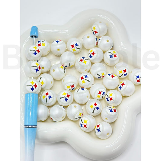 White beads with colorful logos in a heart-shaped container on a white background

