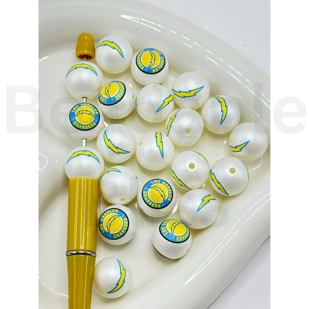 White fishing sinkers with yellow and blue logos on a white background

