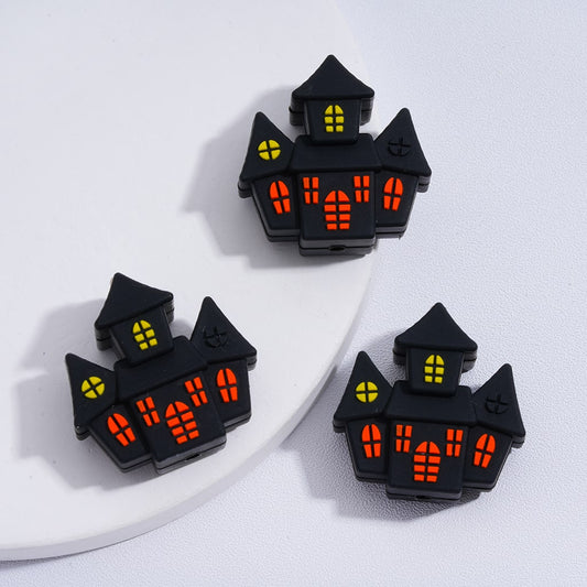 Halloween-themed black house-shaped lights on a white surface

