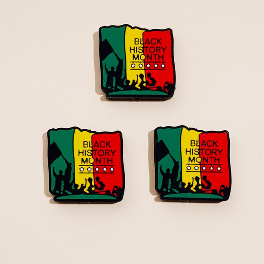 A set of three silicone beads with the Juneteenth Black History Month theme, featuring red and green colors and an illustration of a face.

