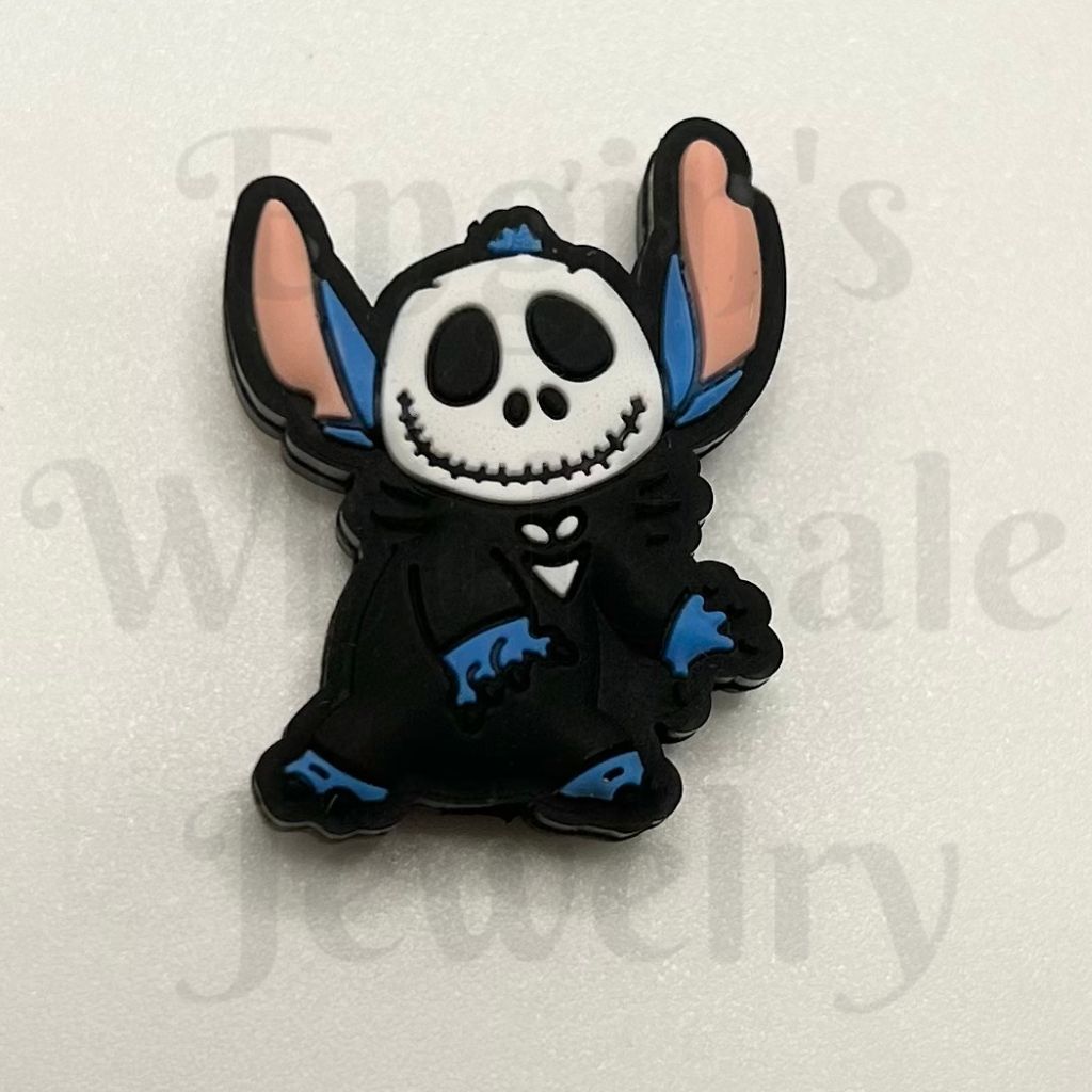 Black plush toy with skull design on a white background

