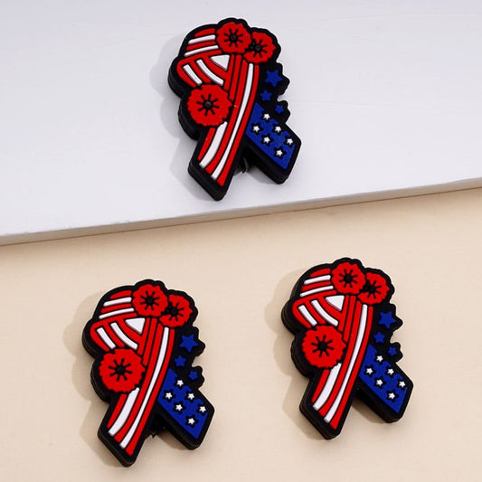 Silicone beads in the shape of a ribbon with the colors of the USA flag and red flowers

