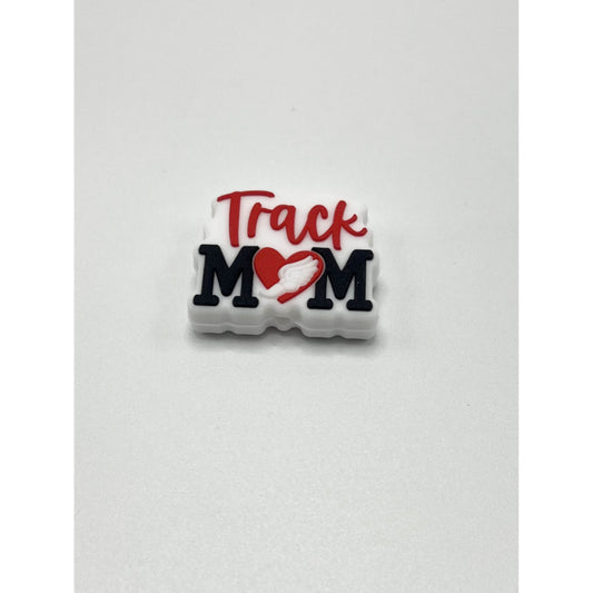 A silicone bead with the text 'Track Mom' and a heart symbol on it, primarily in white color with red and black text.

