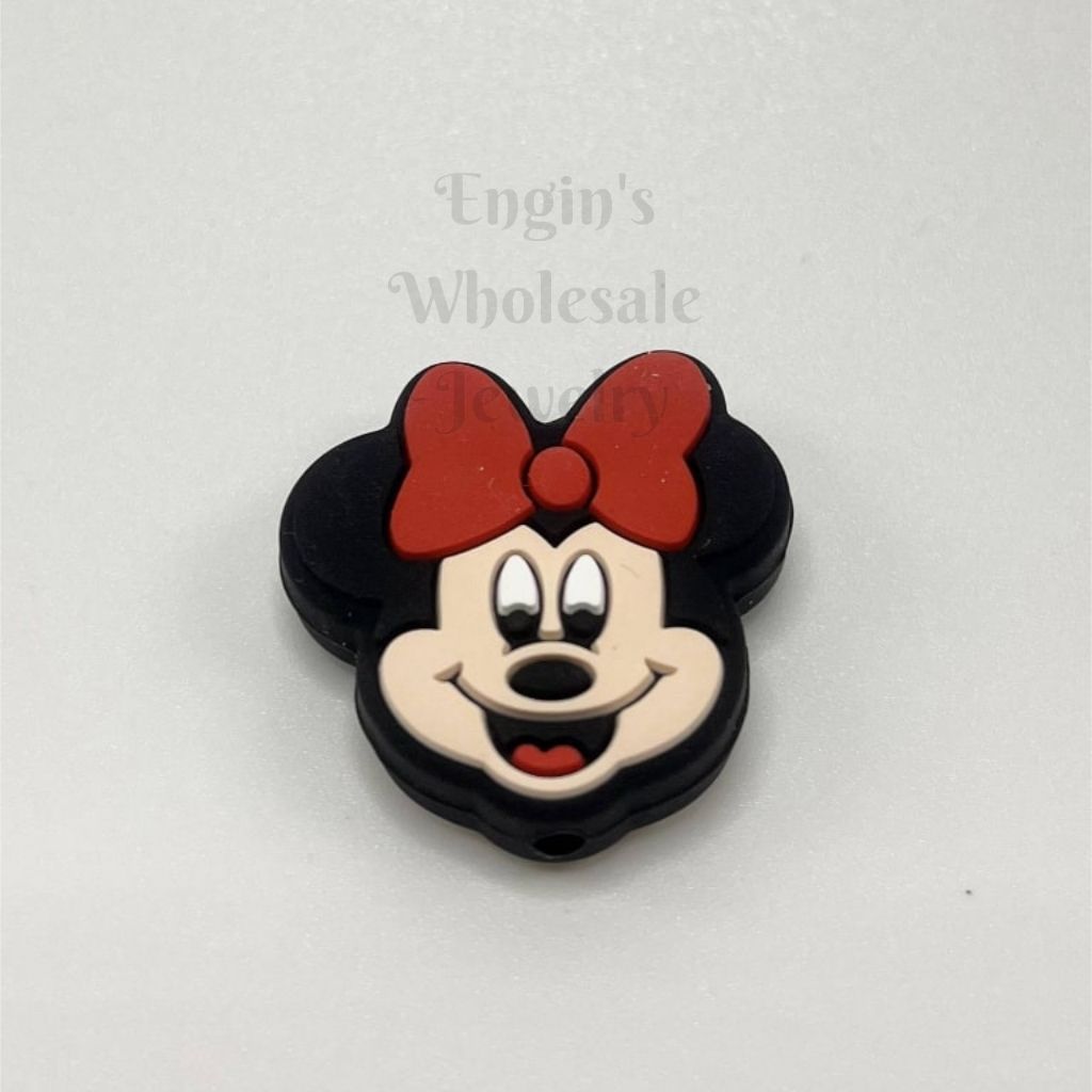 Minnie Mouse head-shaped object with a red bow on a white background

