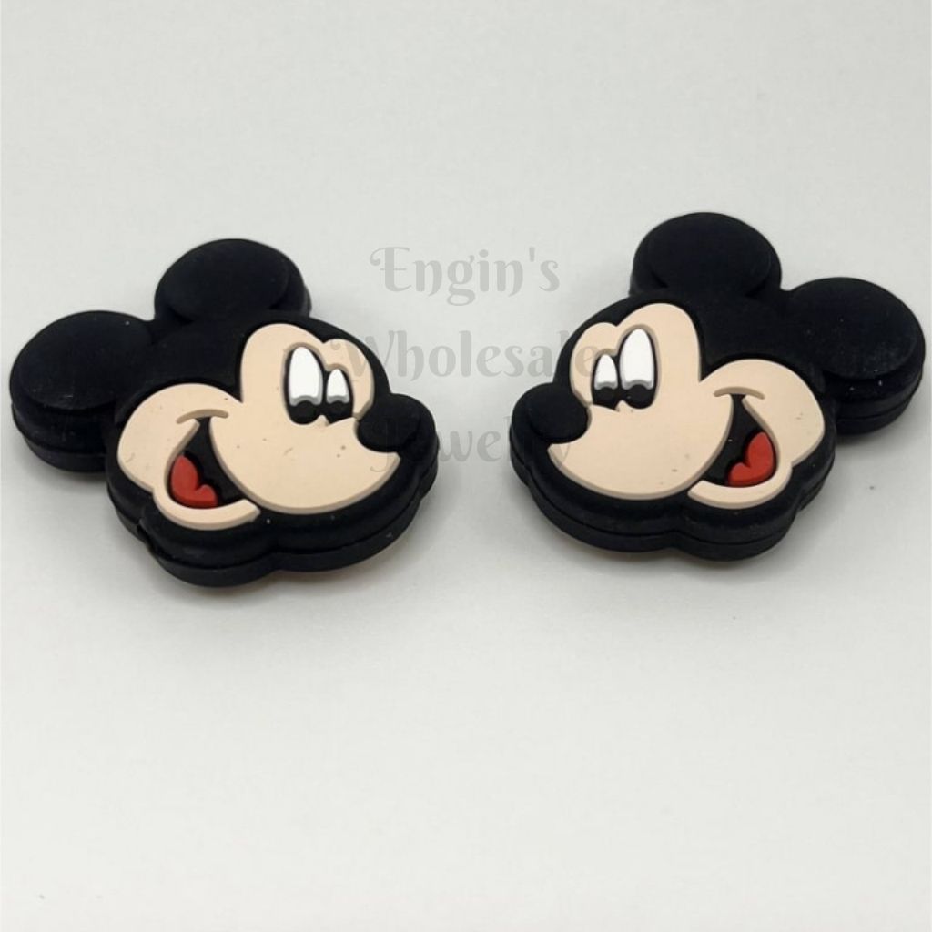 Two black and beige Mickey Mouse earrings on a white background

