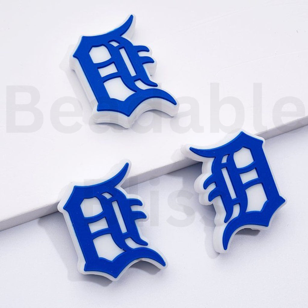 Blue and white earrings with a unique design on a light gray background

