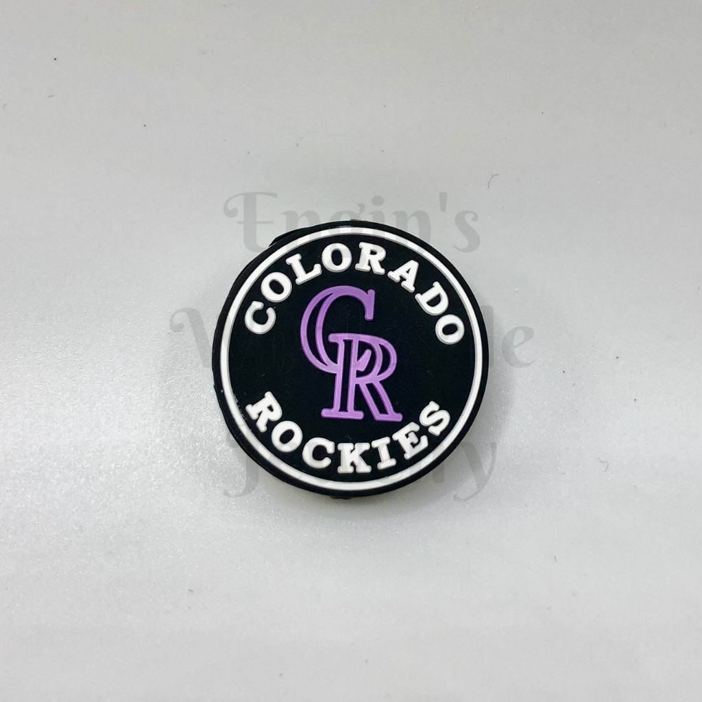 Colorado Rockies logo on a round black and white badge with purple lettering against a light gray background.

