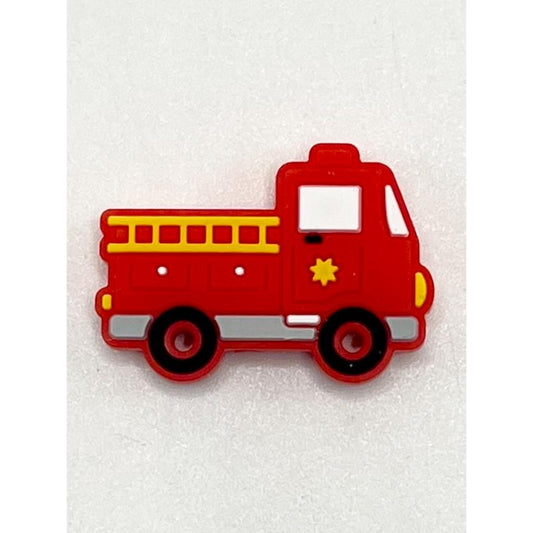 A red silicone bead in the shape of a fire truck with yellow accents on the body, wheels, and ladder.

