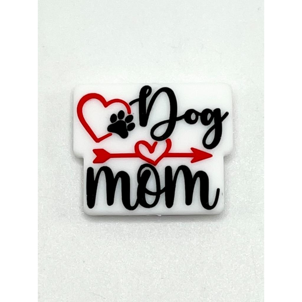 A silicone bead with the text 'Dog mom' and a heart and paw print design

