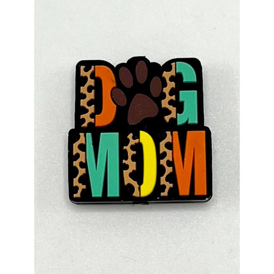 A silicone focal bead with a brown leopard print background and the text 'DOG MOM' in multicolored letters.

