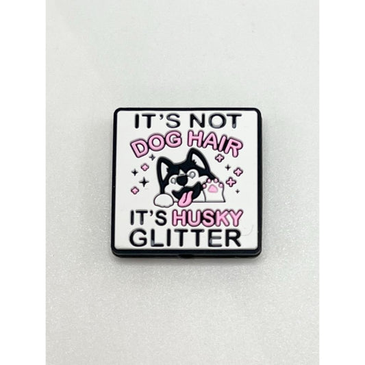 A silicone focal bead with an image of a dog and the text 'It's Not Dog Hair It's Husky Glitter' on a white background.

