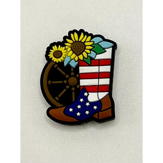 A silicone bead craft shaped like a steering wheel with a boot, featuring stars and stripes pattern, likely representing an American flag motif, with sunflower designs on the top.

