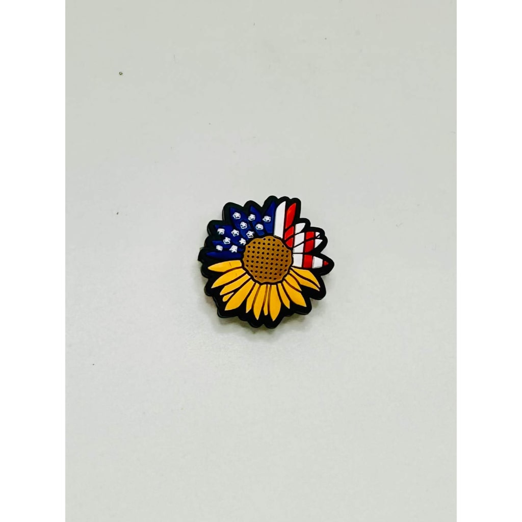 A silicone bead with a sunflower design featuring colors that resemble the American flag.

