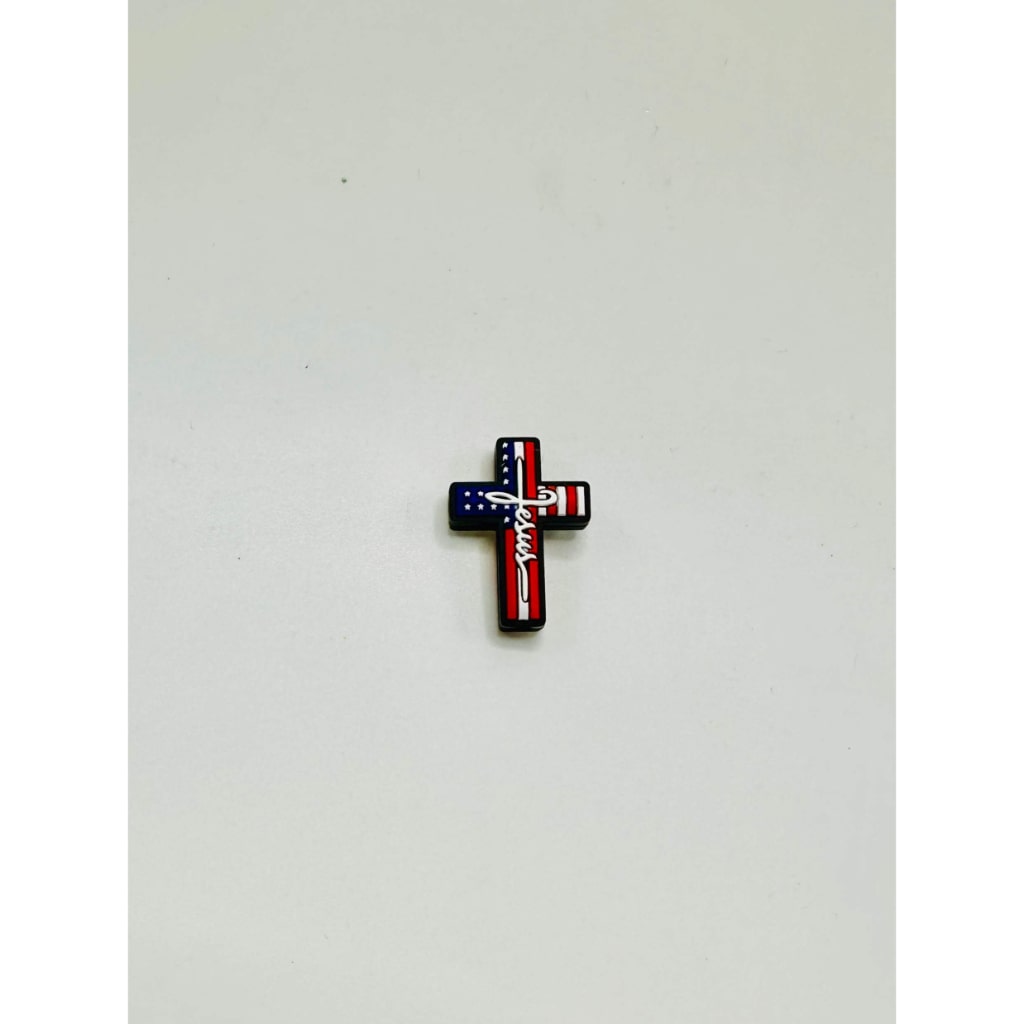 A silicone bead featuring the American flag colors arranged in a cross design on a white background.

