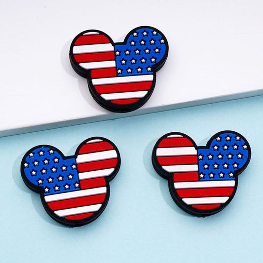 A set of silicone beads designed in the shape of Mickey Mouse heads with the American flag pattern.

