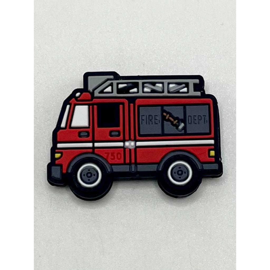 A silicone bead in the shape of a fire fighting truck with the label 'FIRE DEPT' on its side.


