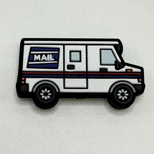 A silicone bead in the shape of a white delivery mail truck with blue and red accents and the word 'MAIL' on the side.

