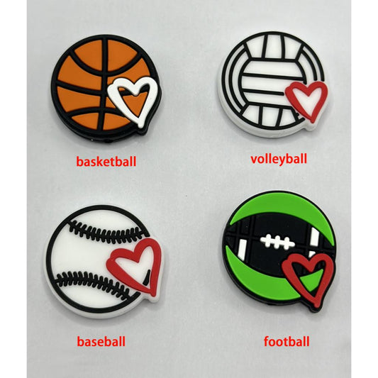 A set of silicone beads in the shapes of sports balls, including basketball, volleyball, baseball, and football, each with a heart shape in red color on them.

