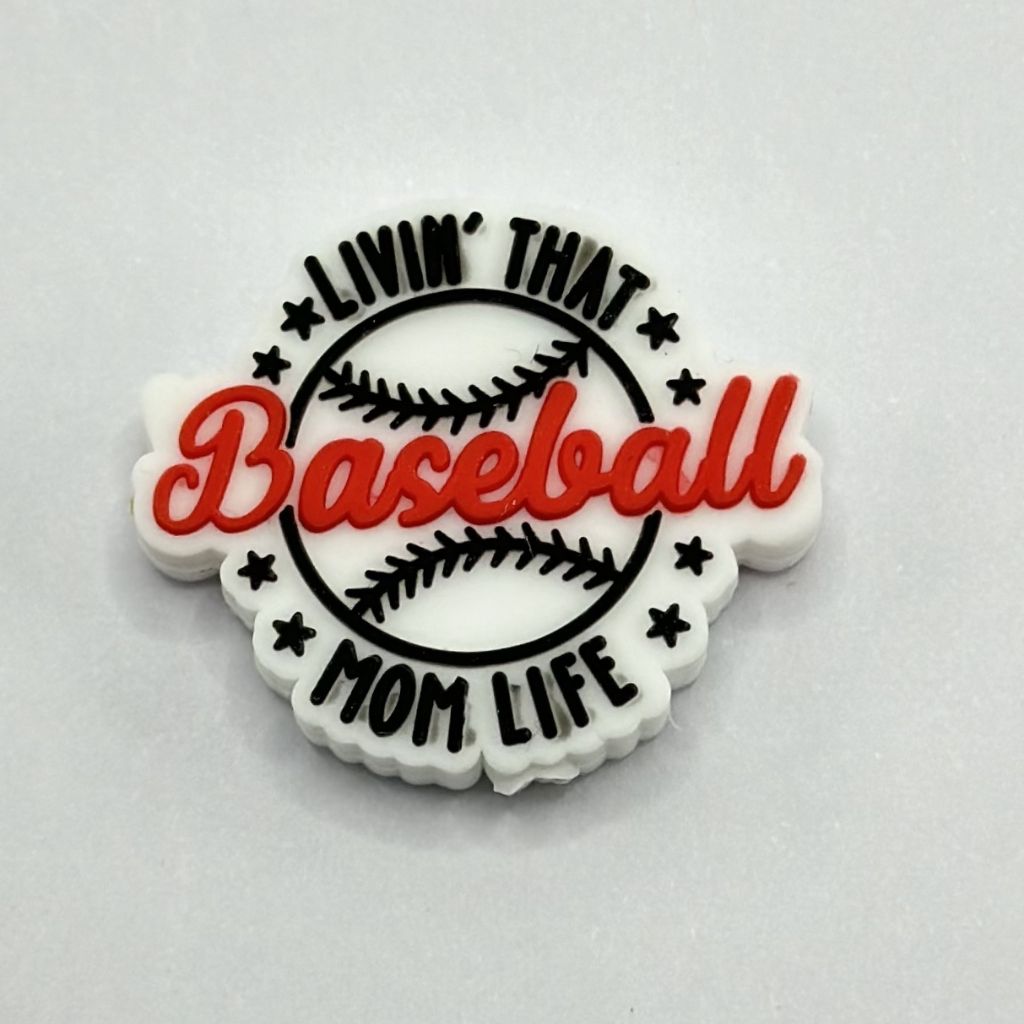 A silicone bead with the text 'Livin' that Baseball Mom Life' arranged in a circular layout with baseball-related graphics such as a baseball and stars.

