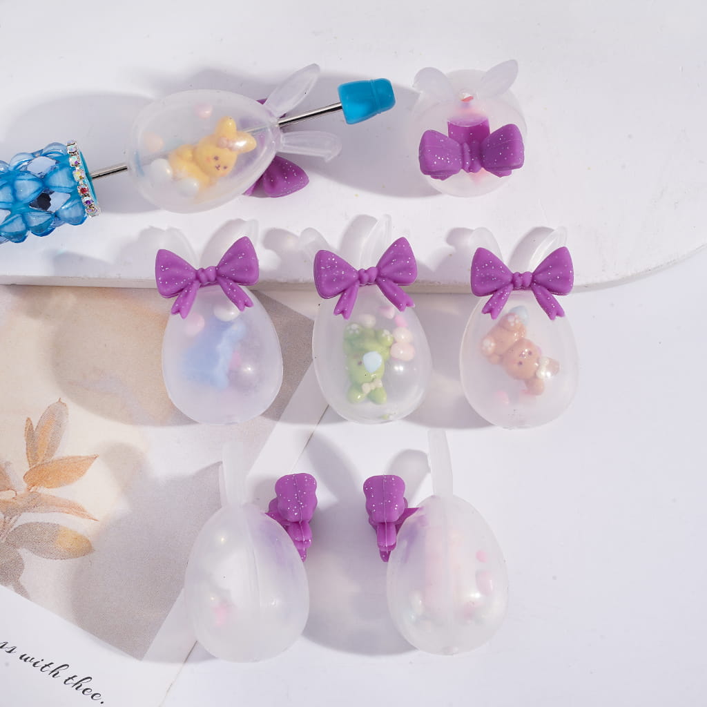 Set of decorative hair clips with purple bows and small figurines on a white background