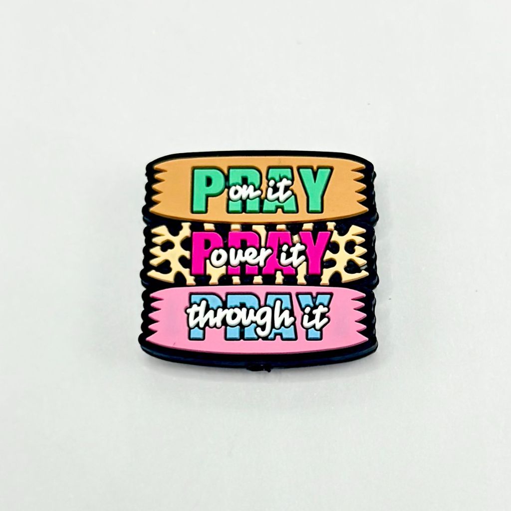 A colorful silicone bead featuring text and patterns with a jaguar print design.

