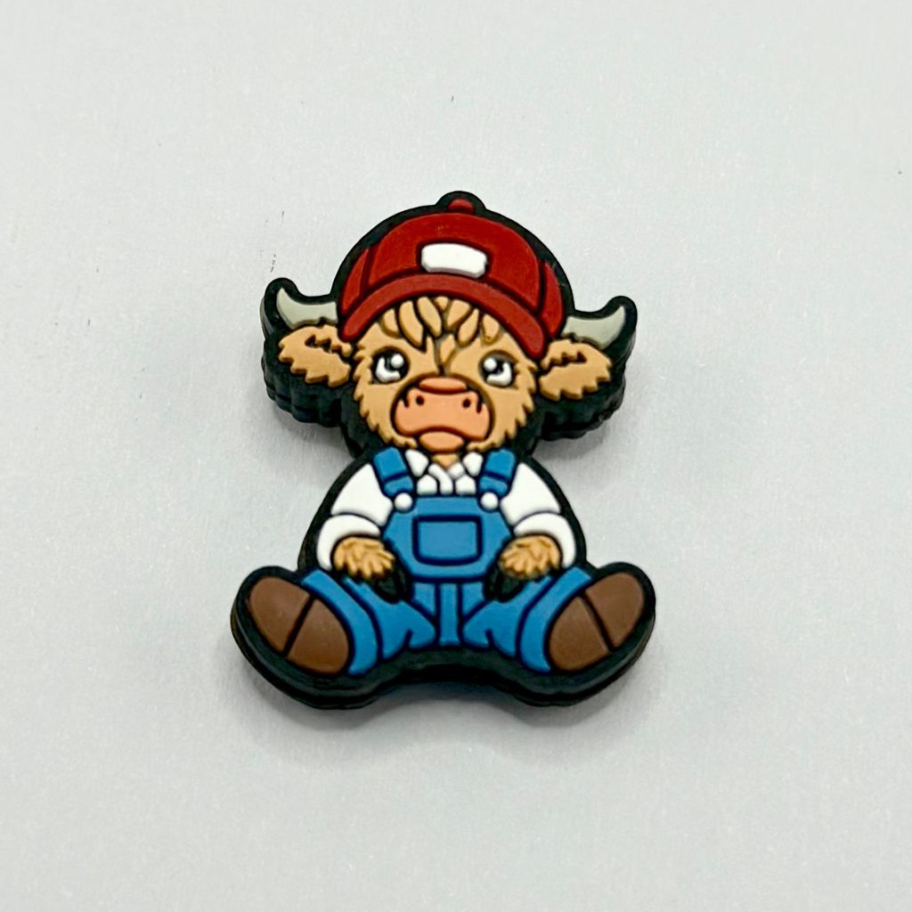 A silicone bead featuring a cartoon cowboy overalls character with a red hat and blue overalls.

